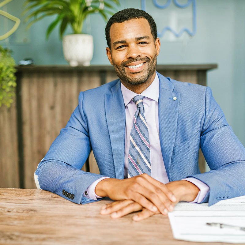 Man Sitting at Table and Smiling