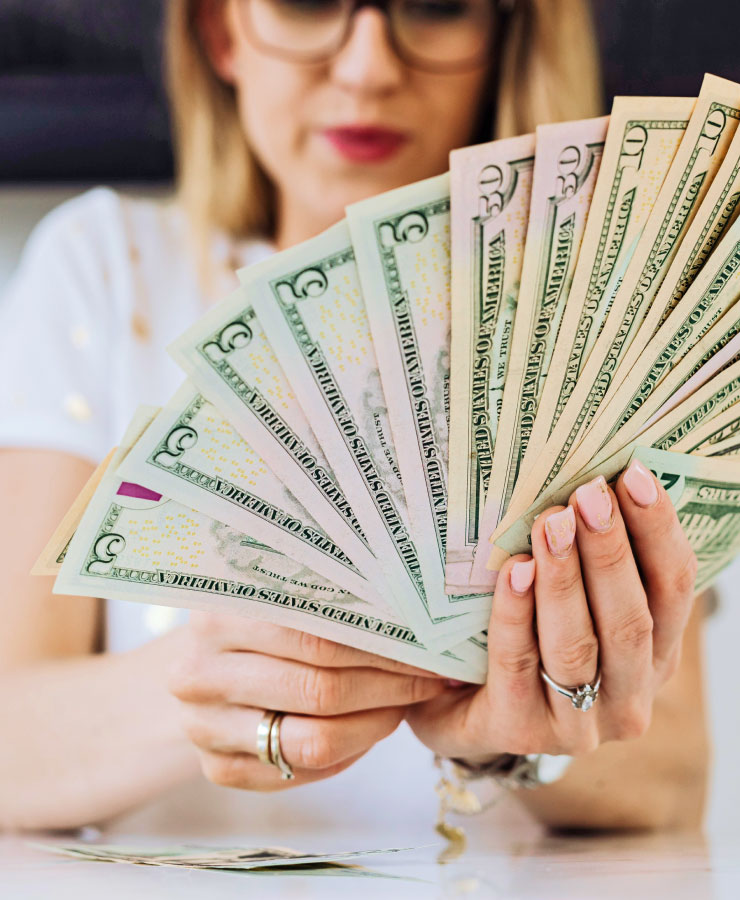 Woman Fanning out Money in Hand